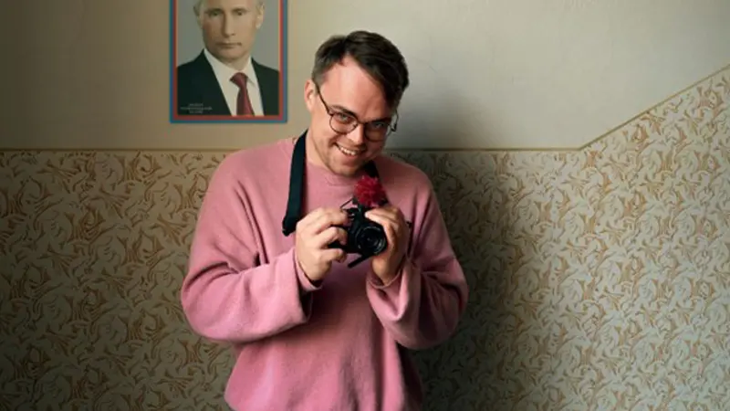 En man håller i en kamera.