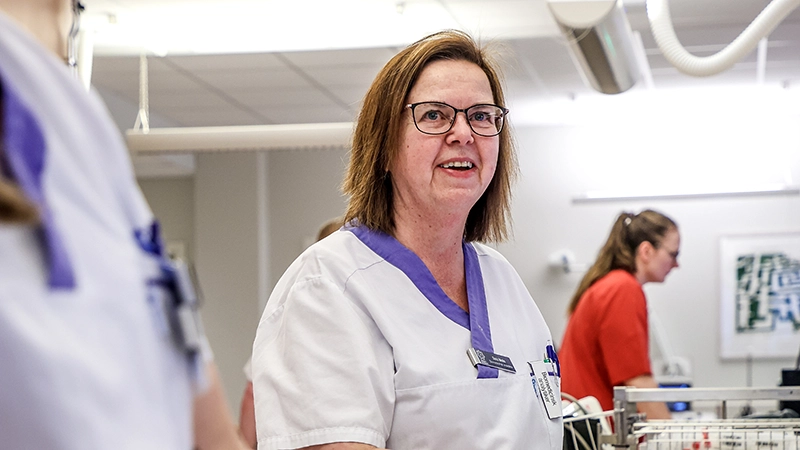 Skrattande kvinna som tittar åt sidan. 