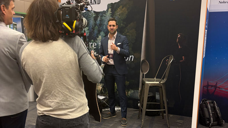 Man in suit being filmed.
