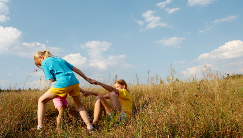barn som leker i högt gräs